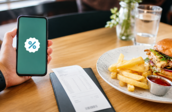 Restaurant coupons online shown on a phone beside a meal and receipt